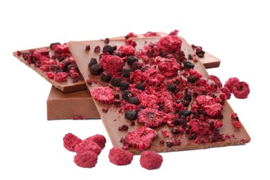 Photo of Chocolate bars with freeze dried berries on white background