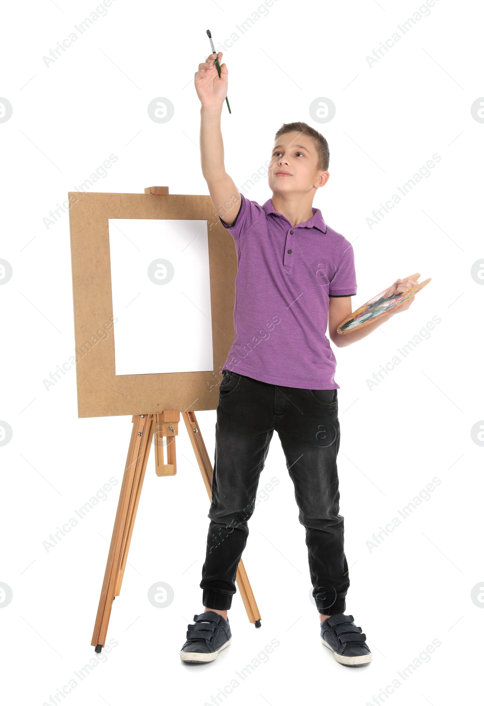 Photo of Child painting picture on easel against white background. Space for text