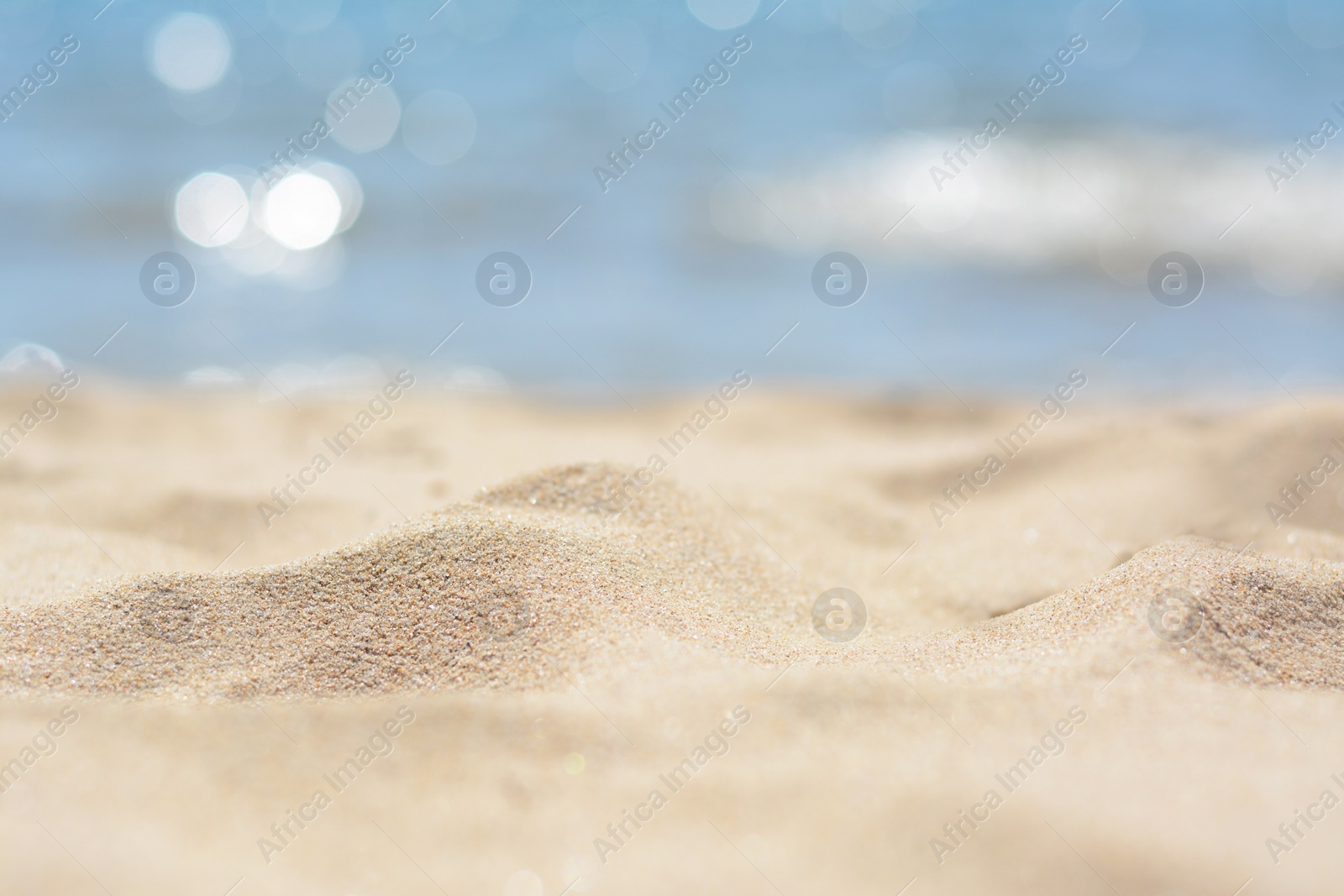 Photo of Sandy beach near sea on sunny day, closeup