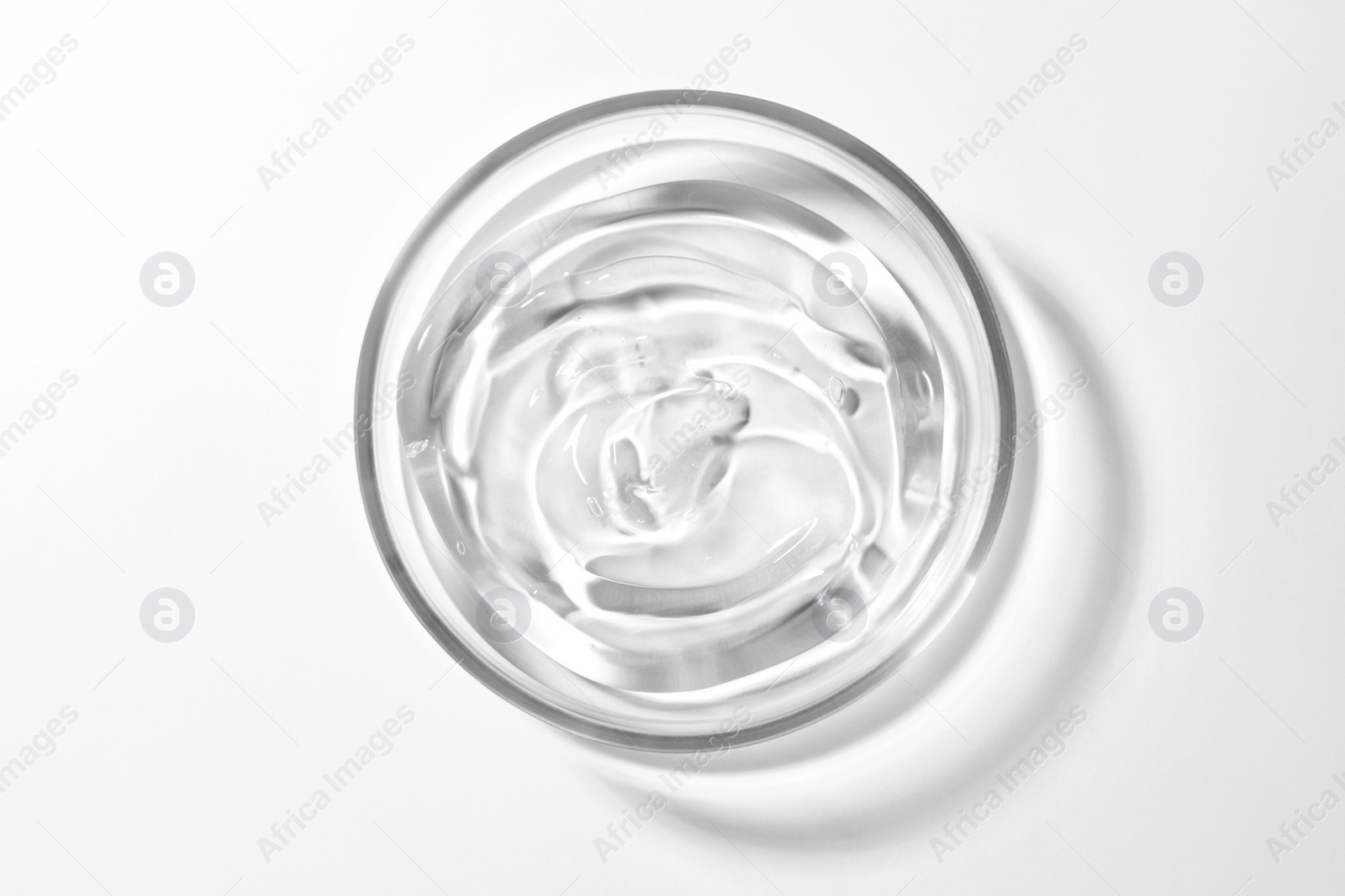 Photo of Petri dish with liquid on white background, top view