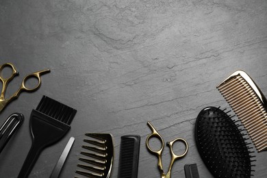 Hairdressing tools on grey textured background, flat lay. Space for text