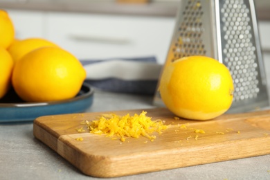 Lemon zest and fresh fruits on grey table, closeup