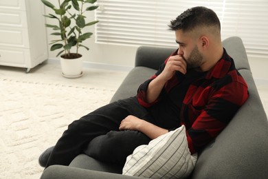 Photo of Sad lonely man on sofa at home