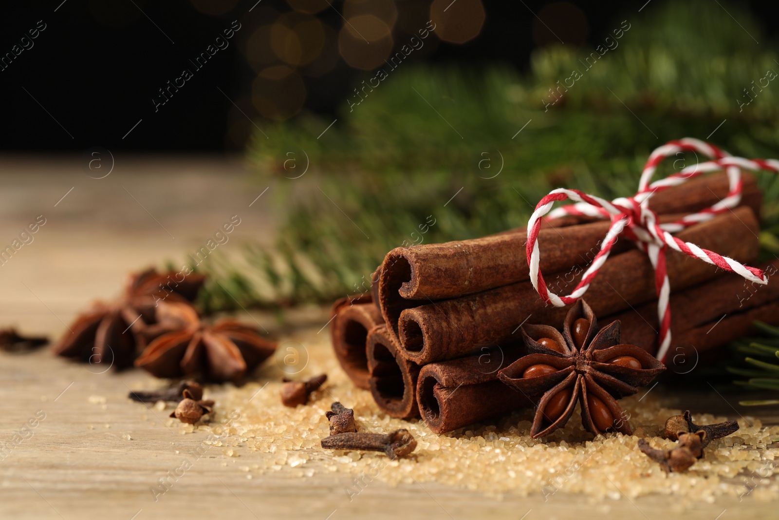 Photo of Different spices on wooden table, closeup. Space for text