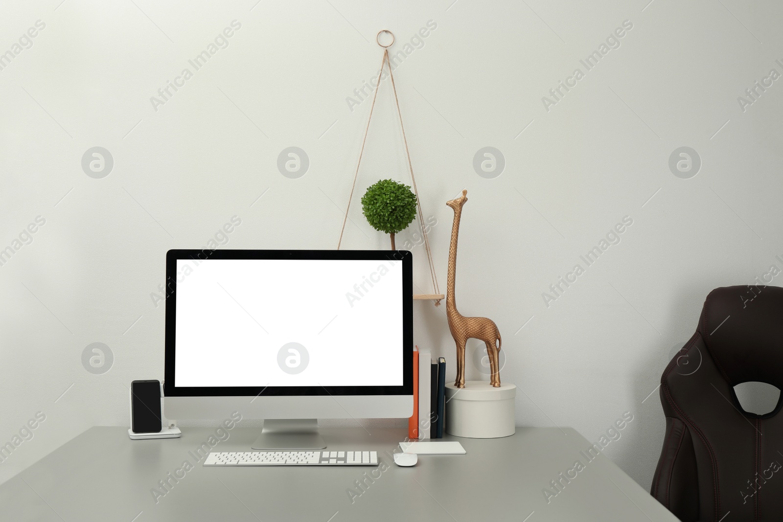 Photo of Modern workplace with computer and decor elements. Interior design