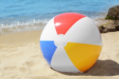 Photo of Colorful beach ball at seaside on sunny day