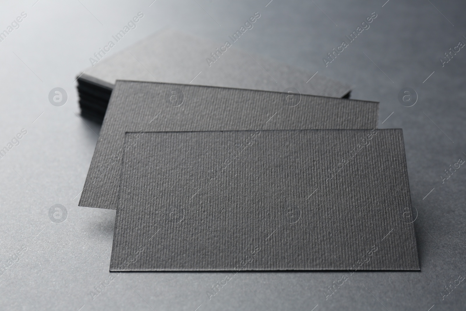 Photo of Blank business cards on black background, closeup. Mockup for design