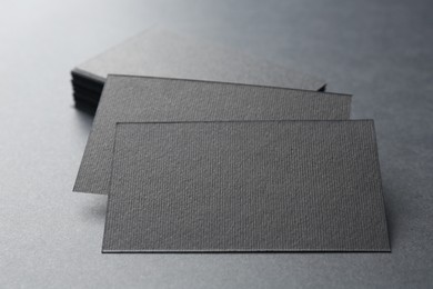 Photo of Blank business cards on black background, closeup. Mockup for design