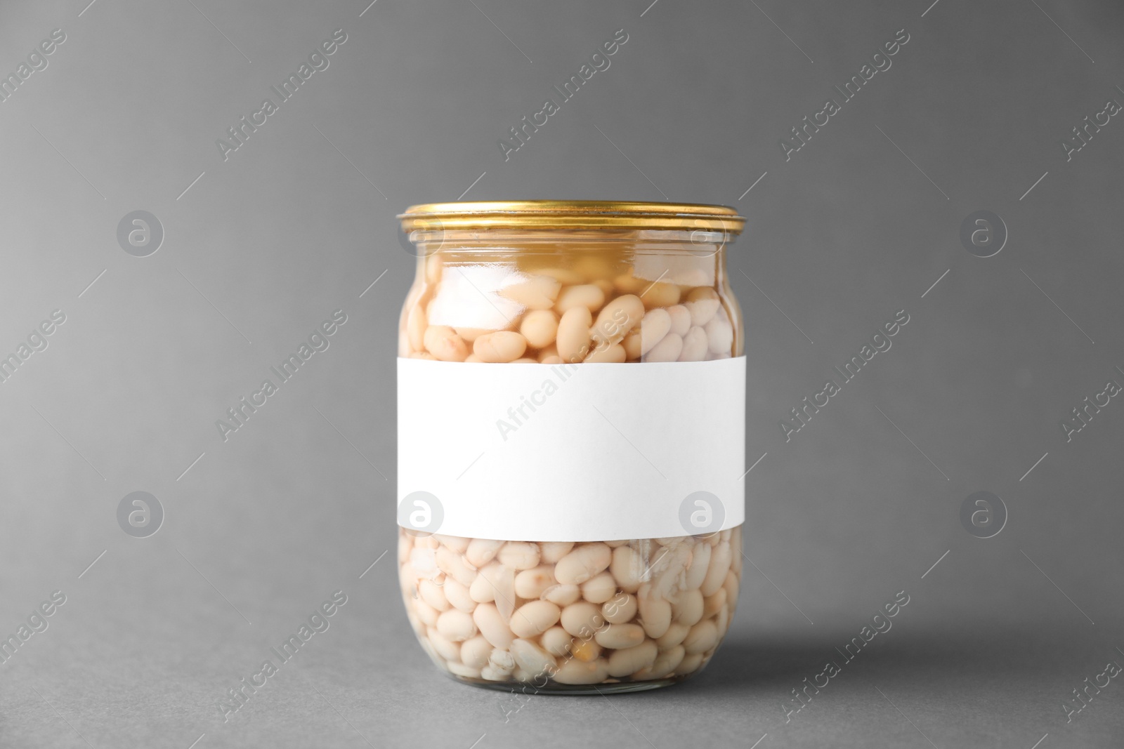 Photo of Jar of pickled beans with blank label on grey background