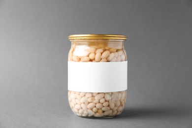 Jar of pickled beans with blank label on grey background