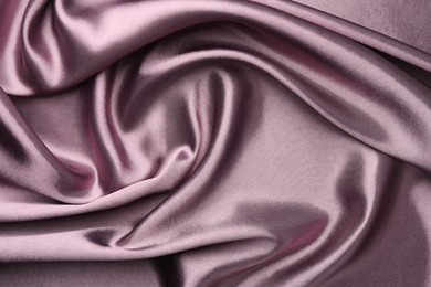 Crumpled dark purple silk fabric as background, top view