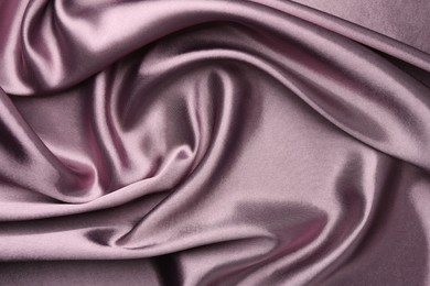 Photo of Crumpled dark purple silk fabric as background, top view