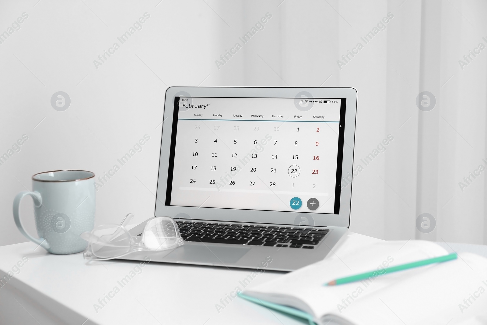 Photo of Modern laptop with calendar on screen in office