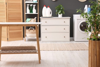 Laundry room interior with washing machine and furniture