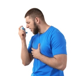 Photo of Young man using asthma inhaler on white background