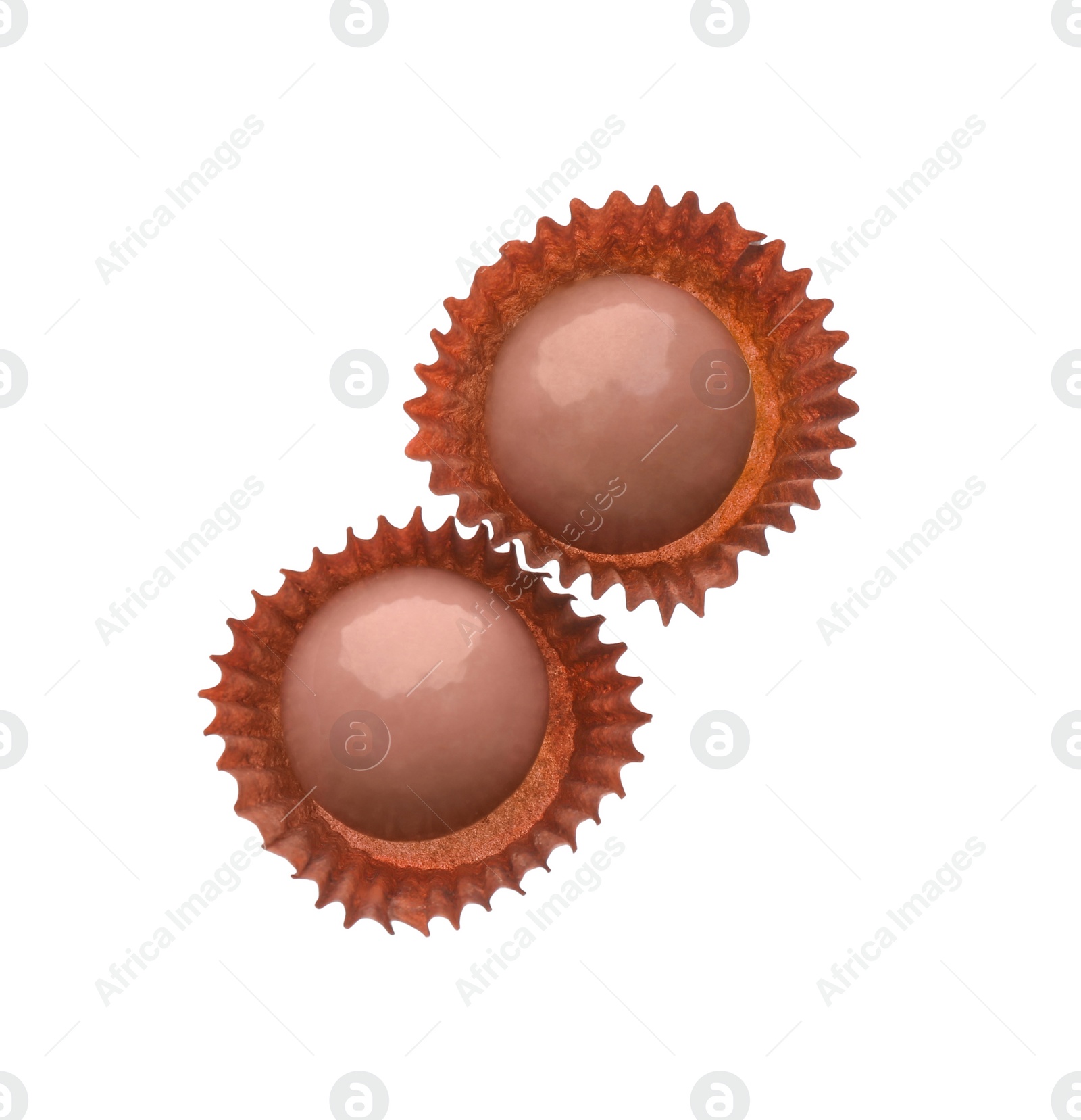 Photo of Delicious pink chocolate candies on white background, top view