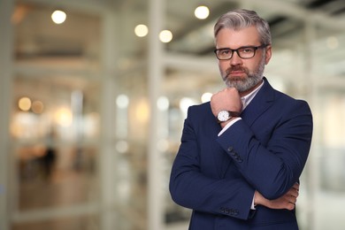 Image of Successful lawyer in glasses on blurred background, space for text