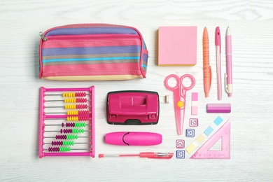 Flat lay composition with different school stationery on wooden background