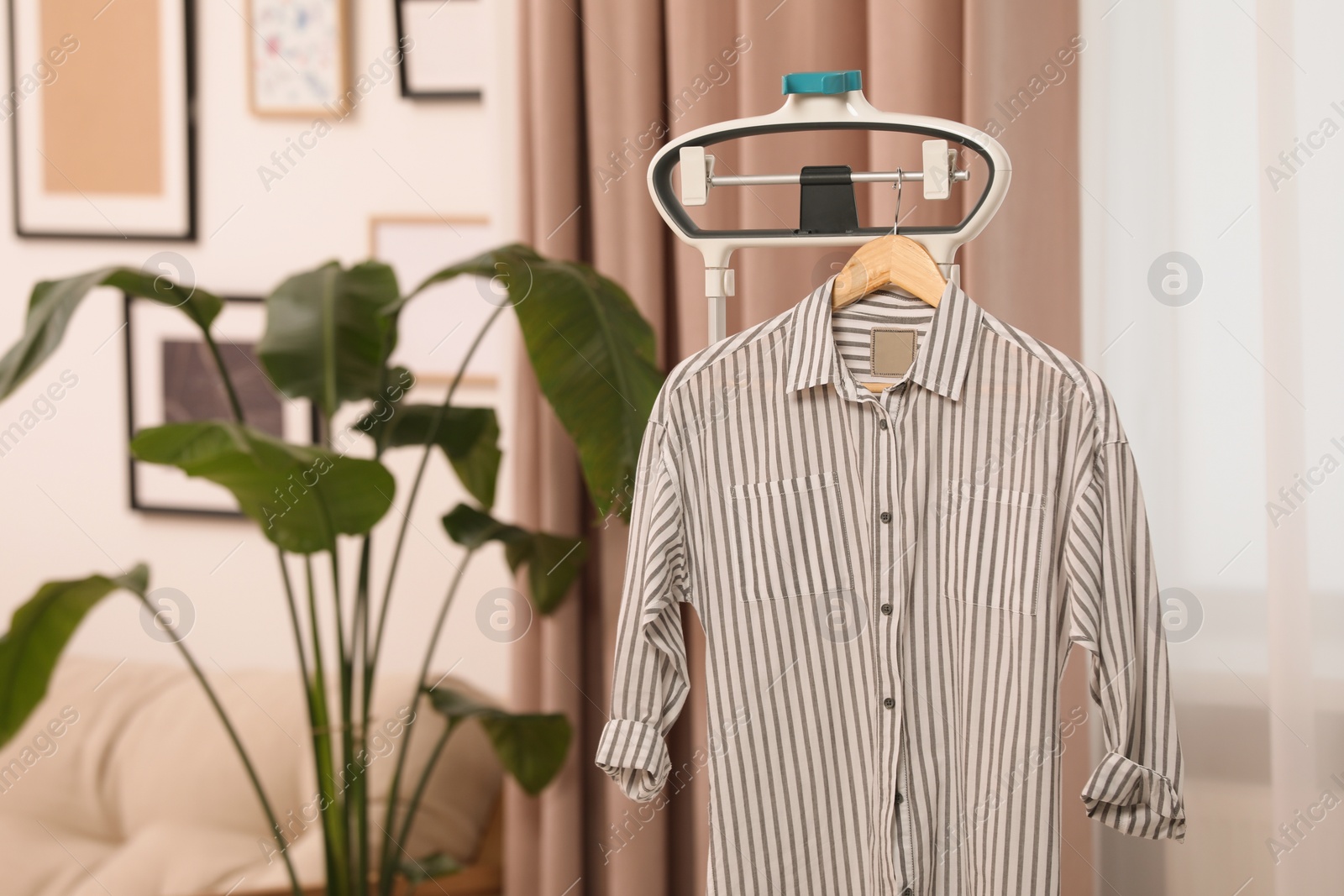 Photo of Shirt on hanger at home, space for text