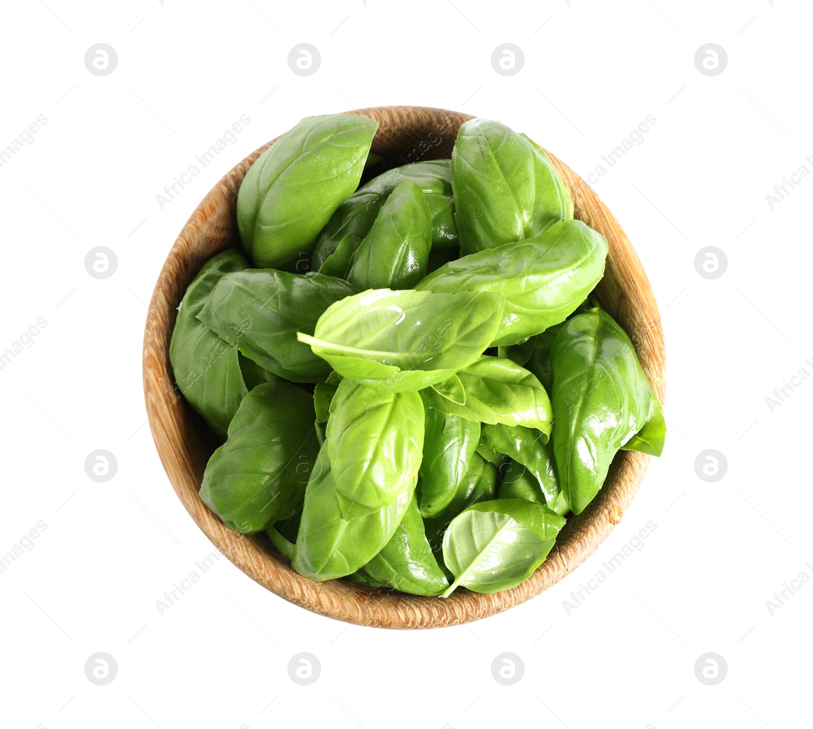 Photo of Fresh green basil leaves in wooden bowl isolated on white, top view