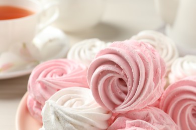 Photo of Different delicious pink zephyrs on white table, closeup