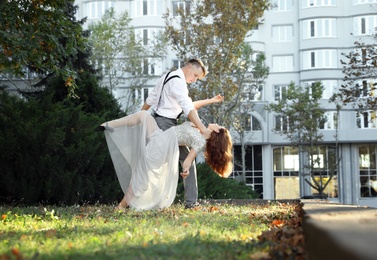 Beautiful young couple practicing dance moves outdoors