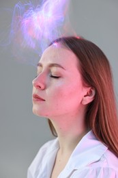 Photo of Fashionable portrait of beautiful young woman on grey background with colorful led lights