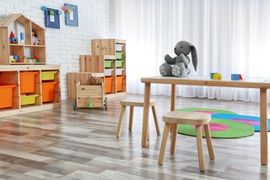 Photo of Modern child room interior with table and stools