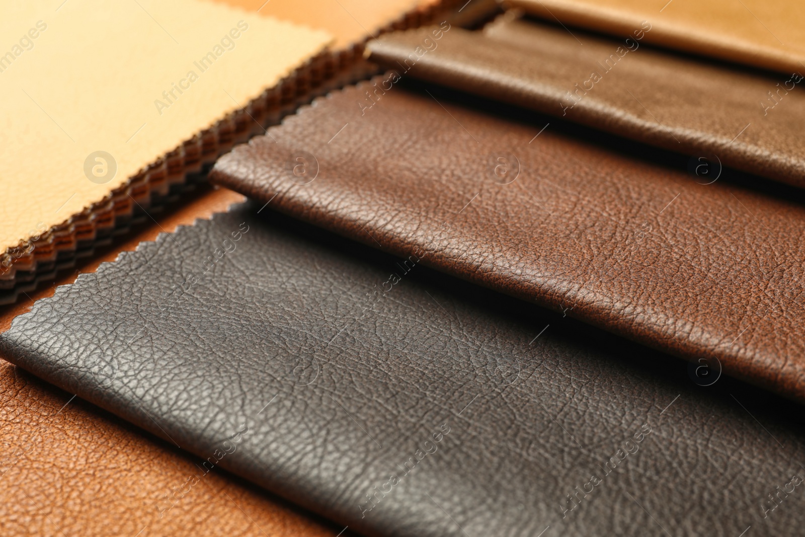 Photo of Leather samples of different colors for interior design on table