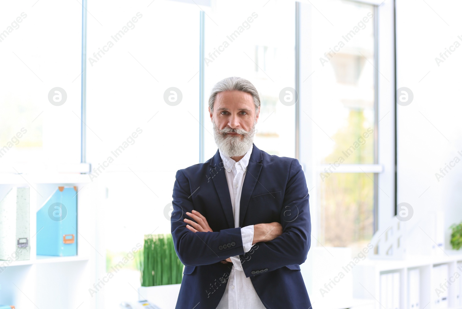 Photo of Portrait of handsome mature man in suit, indoors