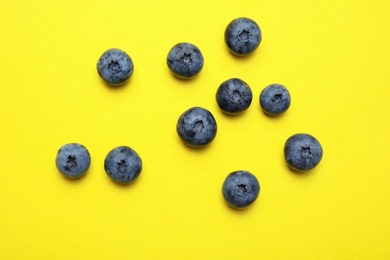 Flat lay composition with tasty blueberry on color background