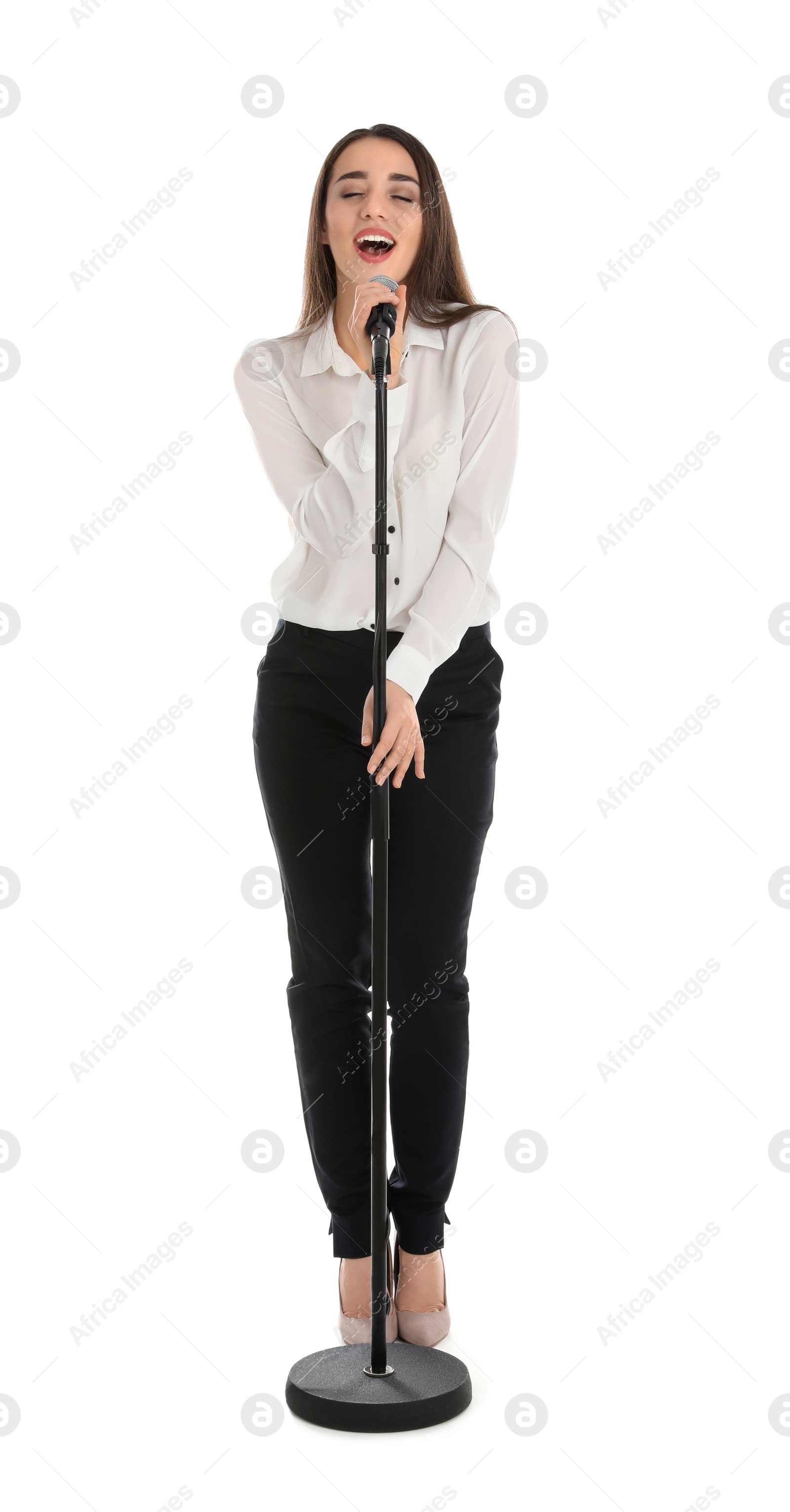 Photo of Young stylish woman singing in microphone on white background