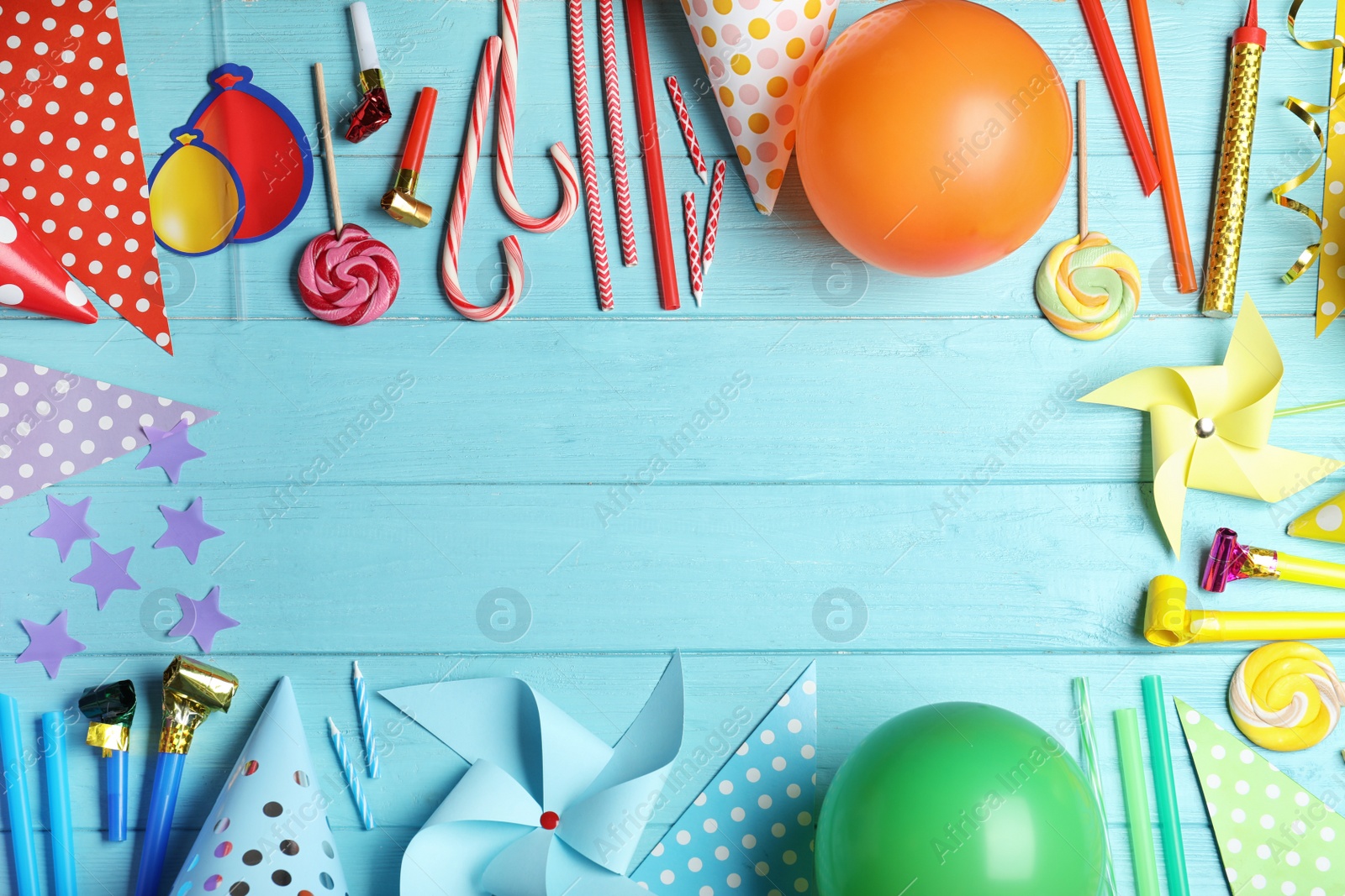 Photo of Colorful birthday accessories on blue wooden background, flat lay. Space for text