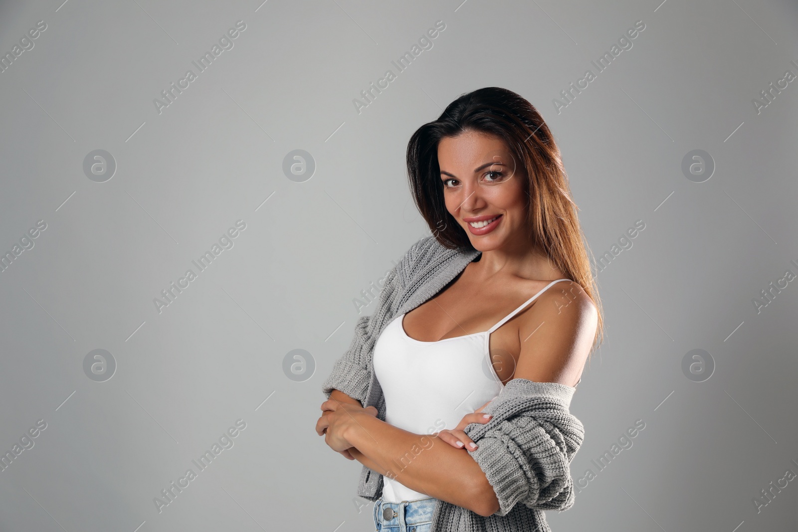 Photo of Portrait of beautiful woman on light grey background, space for text