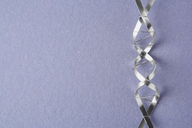 Photo of DNA molecular chain model made of metal on grey background, top view. Space for text