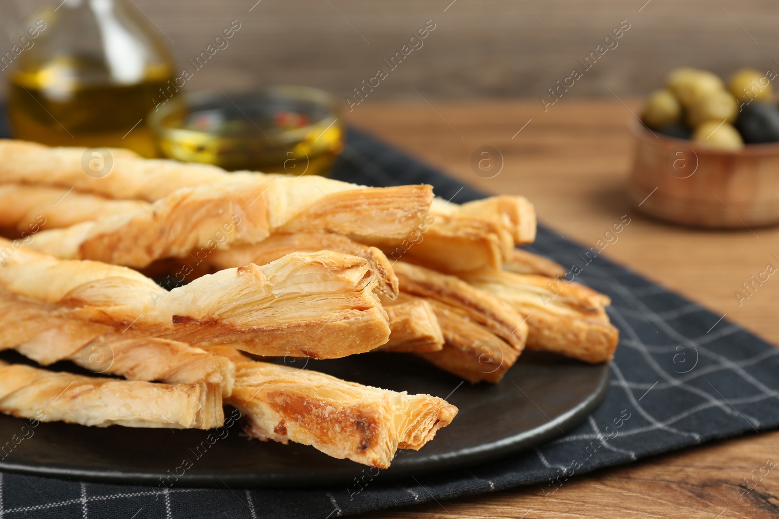 Photo of Tasty grissini on wooden table, closeup view