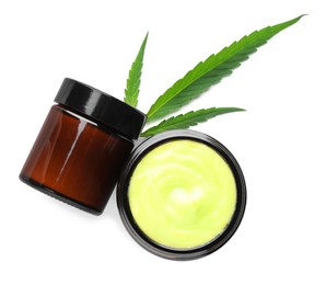 Photo of Jars with hemp cream and green leaf on white background, top view. Natural cosmetics