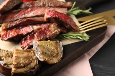 Photo of Delicious grilled eggplant and beef with rosemary on table, closeup
