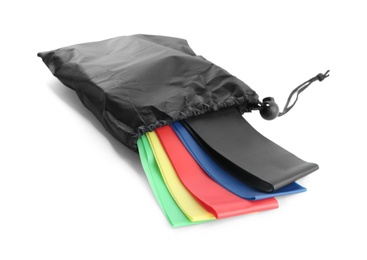 Photo of Black bag with colorful elastic resistance bands isolated on white. Fitness equipment