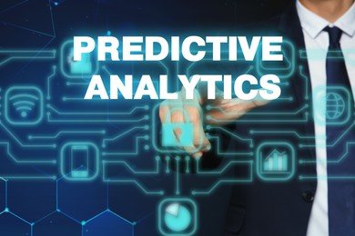 Image of Concept of predictive analytics. Businessman pointing at phrase on virtual screen, closeup