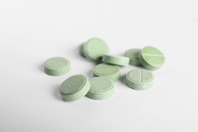 Photo of Many light green pills isolated on white