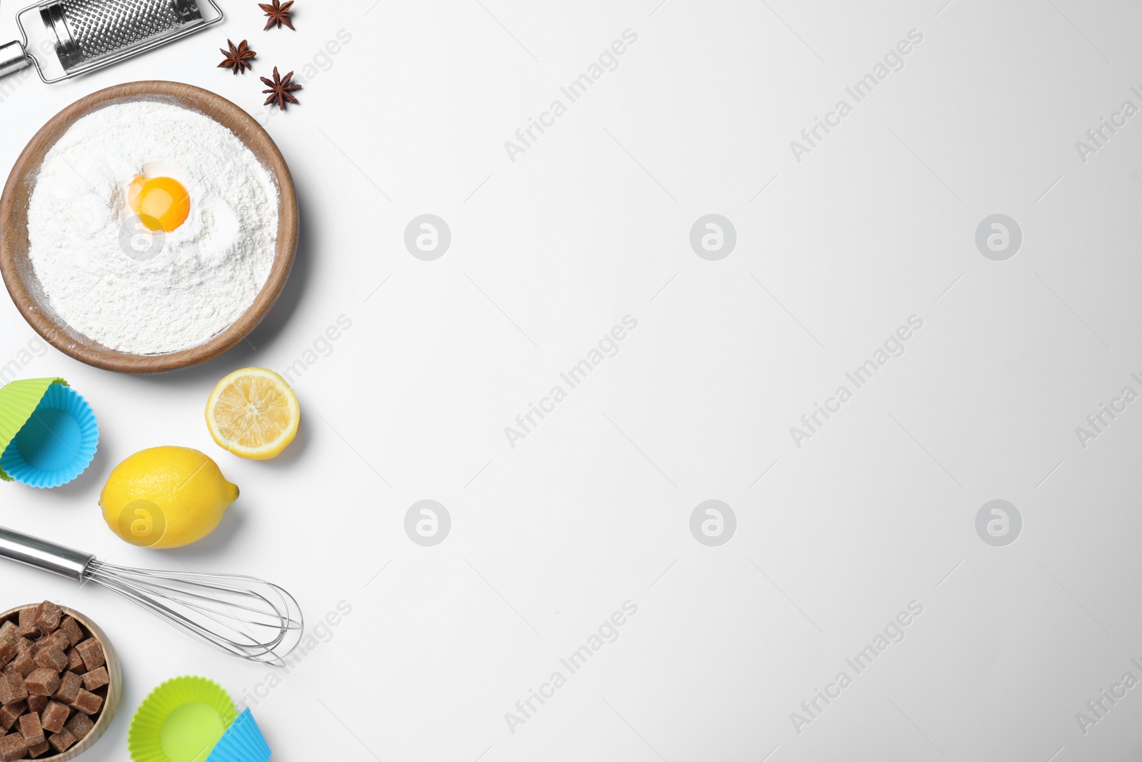 Photo of Cooking utensils and ingredients on light background, flat lay. Space for text