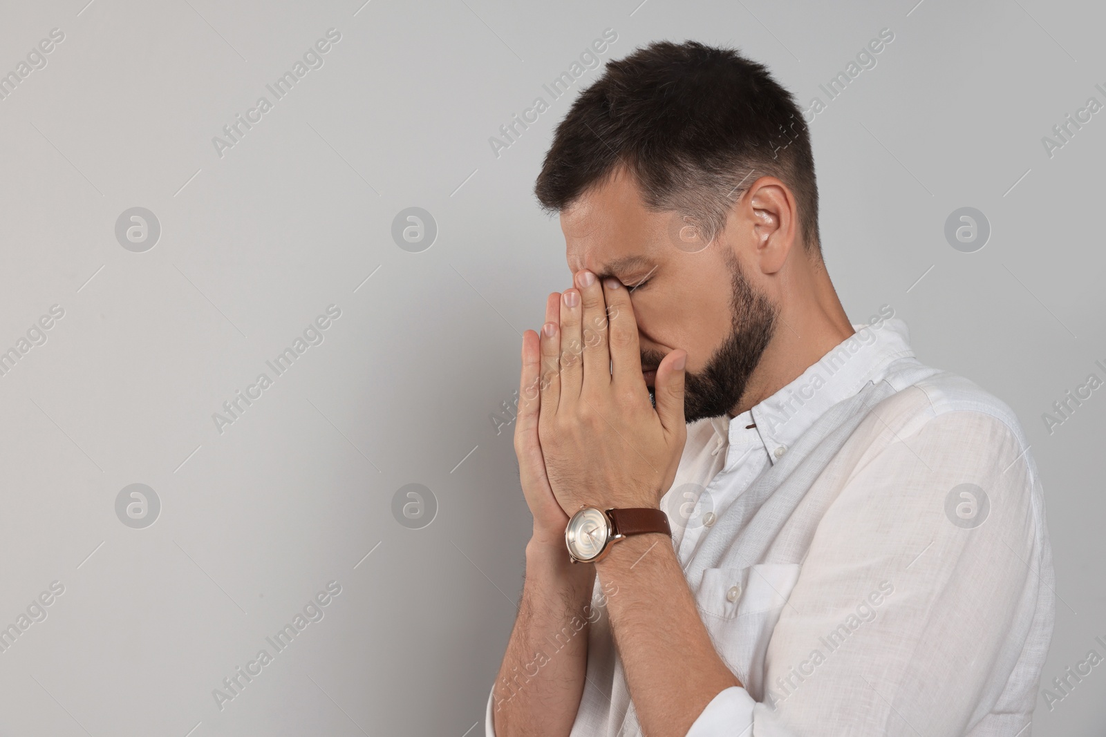 Photo of Man suffering from eyestrain on light background, space for text