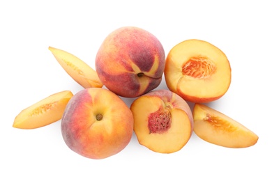 Photo of Whole and cut ripe peaches isolated on white, top view