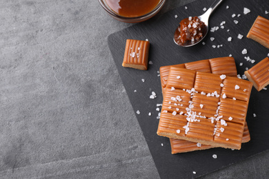 Photo of Salted caramel on light grey table, flat lay. Space for text