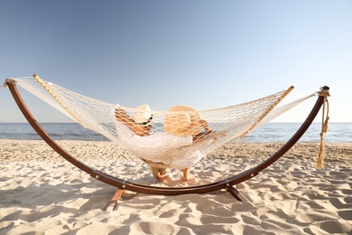 Photo of Couple. Summer vacation relaxing in hammock on beach