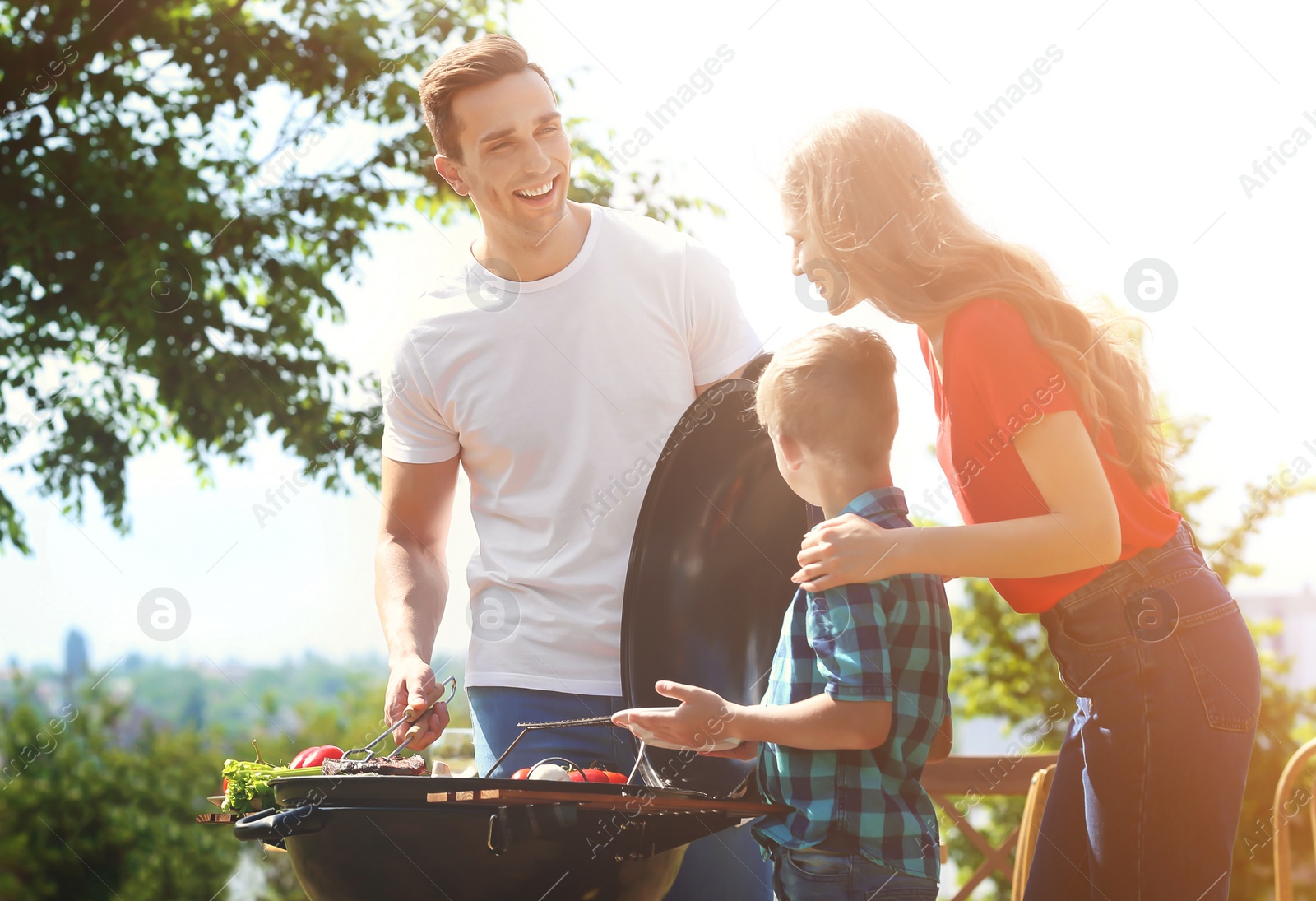 Image of Happy family having barbecue with modern grill outdoors on sunny day