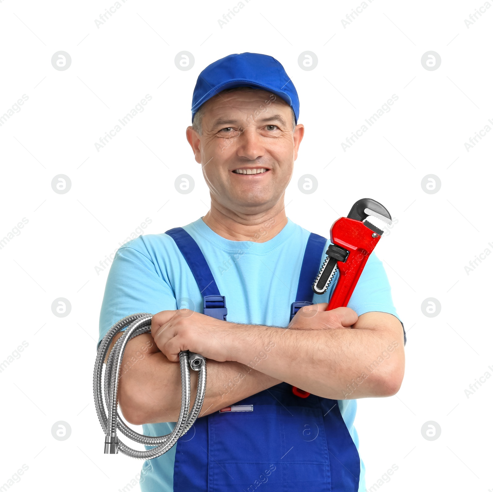 Photo of Mature plumber with pipe wrench and hose on white background