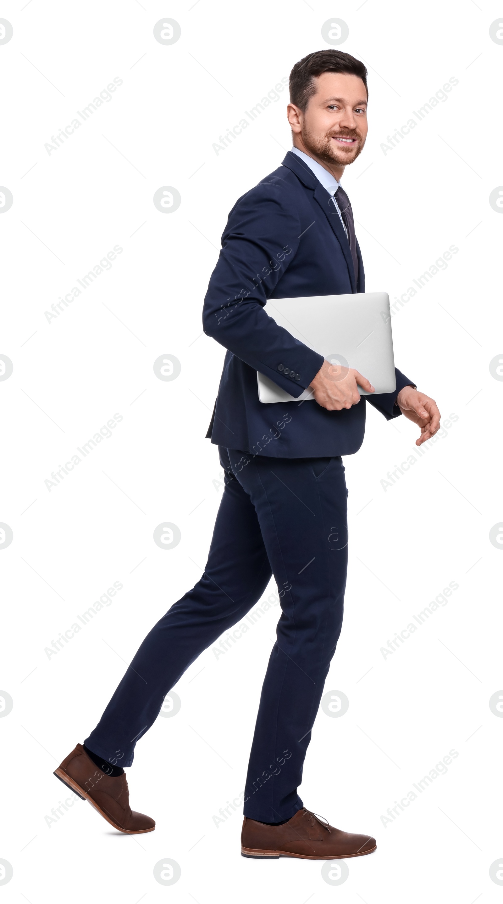 Photo of Handsome bearded businessman in suit with laptop on white background