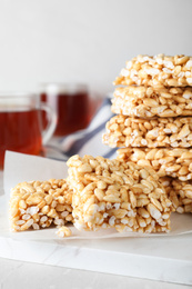 Photo of Delicious rice crispy treats on light grey table